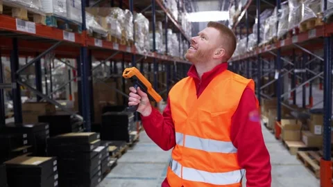 Warehouse worker scanning barcodes on high shelves Stock-Footage 312856339