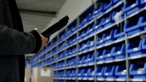 Warehouse Worker Scanning Blue Storage Bins, Logistics Center, Medium Shot Vídeo Stock 341434071