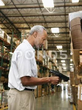 Warehouse worker scanning delivery Stock Photos