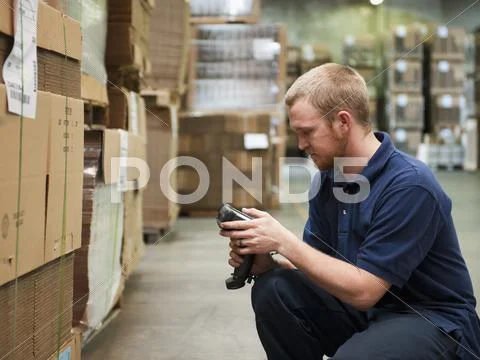 Warehouse worker scanning delivery Stock Photos