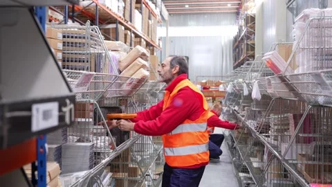 Warehouse worker scanning packages with barcode reader Stock Footage 312856292