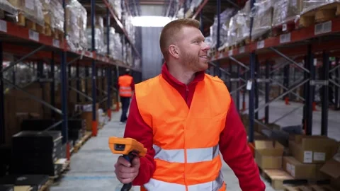 Warehouse worker scanning packages with barcode scanner Stock Footage 312856322