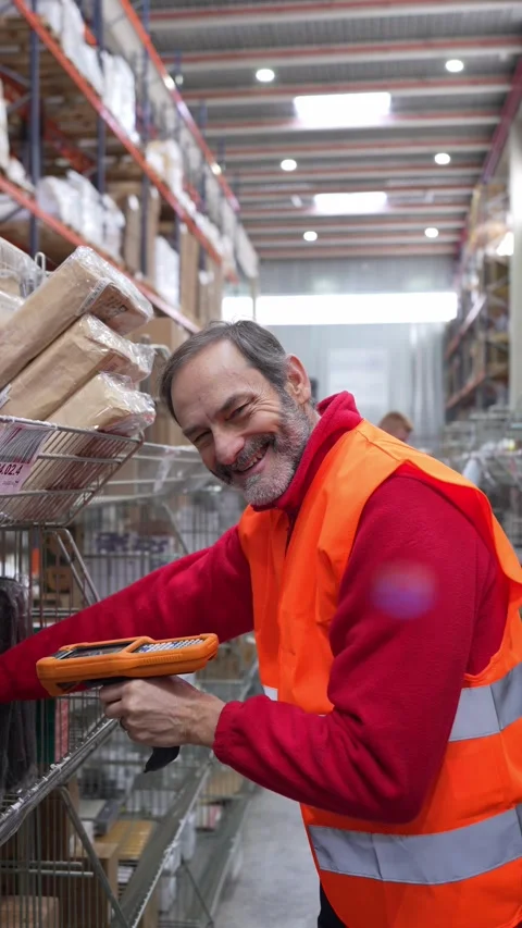 Warehouse worker scanning packages with barcode scanner Stock Footage 312856479