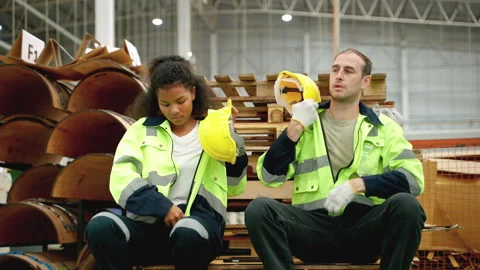 Warehouse worker sitting and resting between breaks, tired, labor concept Stock Footage 252090745