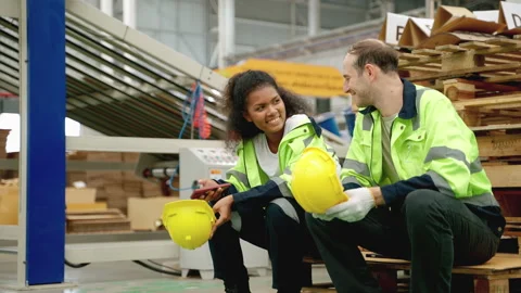Warehouse worker sitting and resting between breaks, tired, labor concept Stock Footage 252610129