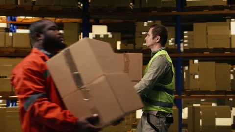 Warehouse worker stacking cargo pallets in distribution hub facility Stock Footage 332908770