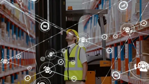 Warehouse worker standing in aisle, viewing floating network icons over boxes, 스톡 동영상 309107497