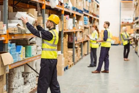 Warehouse worker taking package in the shelf Foto stock