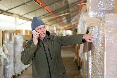 Warehouse worker talking on phone Stock Photos
