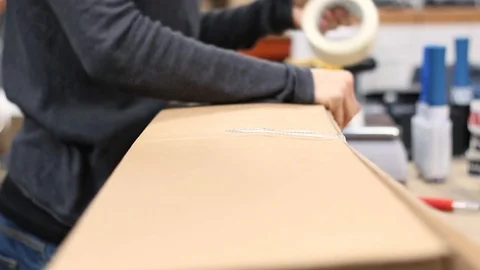 Warehouse Worker Taping Up A Large Parcel To Be Shipped. Stock Footage 99601380