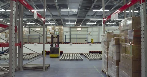 Warehouse worker transports boxes trolley loader 4k video. Delivery man rolling Stock Footage 72219456