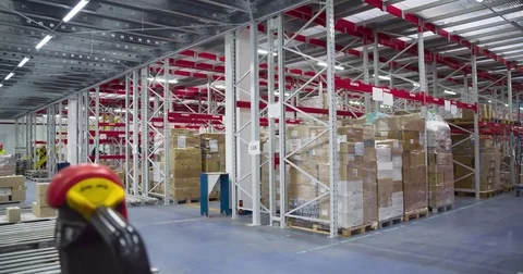 Warehouse worker transports boxes trolley loader 4k video. Delivery man unloads Stock Footage 72219462