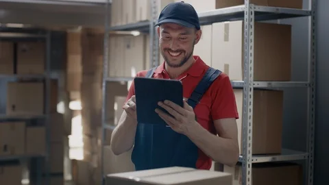 Warehouse Worker Uses Digital Tablet For Checking Stock, On the Shelves Stock Footage 96143270