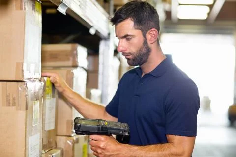 Warehouse worker using barcode scanner in distribution warehouse Stock Photos