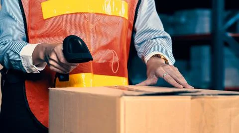 Warehouse worker using barcode scanner in storehouse 스톡 사진