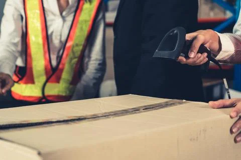 Warehouse worker using barcode scanner in storehouse Stock-Fotos