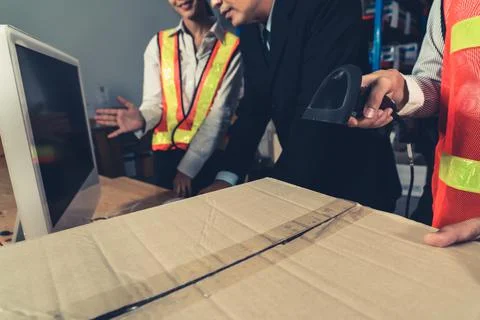 Warehouse worker using barcode scanner in storehouse 스톡 사진