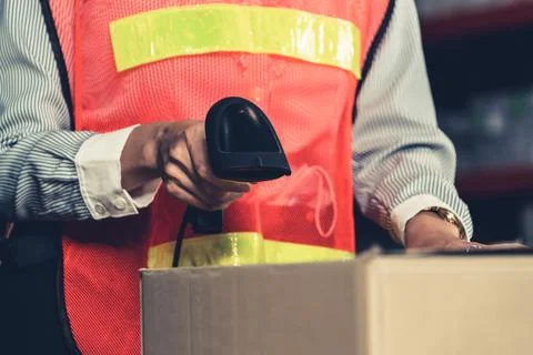Warehouse worker using barcode scanner in storehouse Stock Photos