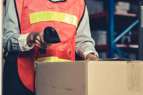 Warehouse worker using barcode scanner in storehouse Stock-Fotos