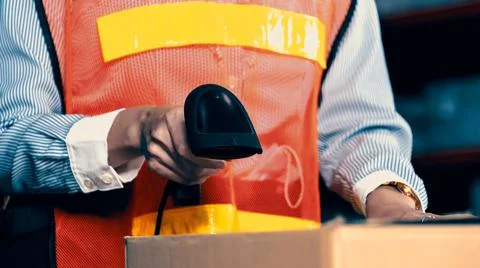 Warehouse worker using barcode scanner in storehouse 写真素材