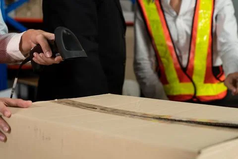 Warehouse worker using barcode scanner in storehouse Stock-Fotos