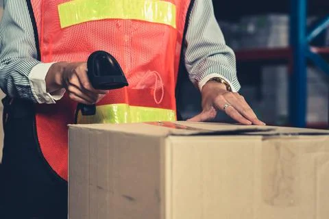 Warehouse worker using barcode scanner in storehouse 스톡 사진