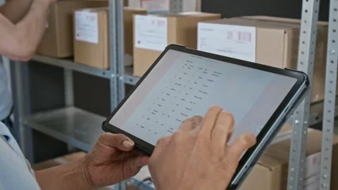 Warehouse Worker Using Digital Tablet for Order Fulfillment Stock Footage 346059493