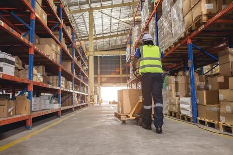 Warehouse worker using hand pallet trucks loading cargo for shipping logist.. Stock Photos