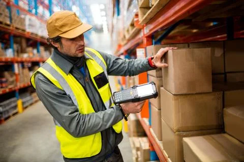 Warehouse worker using hand scanner in a warehouse Foto stock