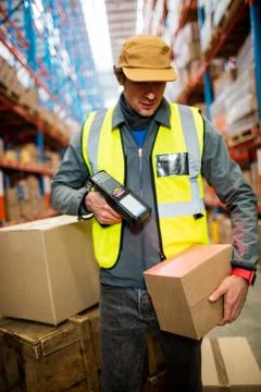 Warehouse worker using hand scanner in a warehouse Foto stock