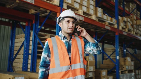 Warehouse worker using a phone working in a distribution center Video stock 163348461