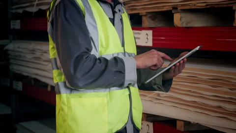 Warehouse Worker Using Tablet to Check Materials and Inventory Stock Footage 345012909