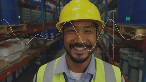 Warehouse worker wearing hard hat and vest monitoring sensor data with waveform Stock Footage 333336641