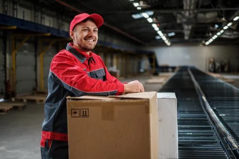 Warehouse worker working on a conveyor line Stock Photos