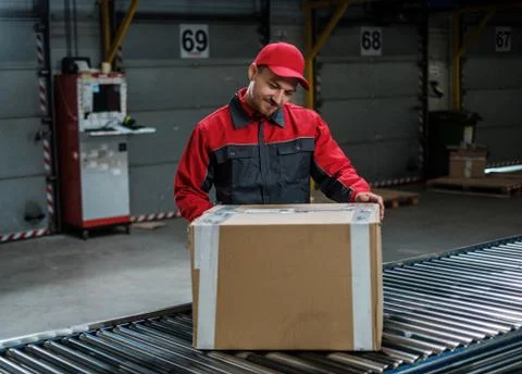 Warehouse worker working on a conveyor line Foto stock