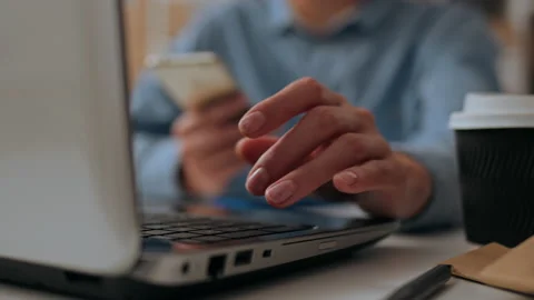 Warehouse worker working on laptop arranging shipments for delivery online, Stock Footage 220629567