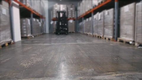 Warehouse worker with a yellow hand pallet truck 動画素材 76754479