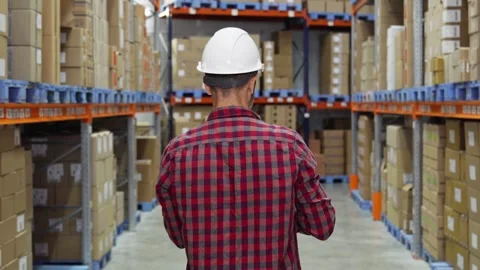 Warehouse workers checking and controlling boxes in warehouse using tablet. Stock Footage 285311888