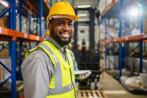 Warehouse workers checking and controlling boxes in warehouse Stock Photos