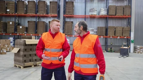 Warehouse workers discussing logistics and inventory management Stock Footage 312856295