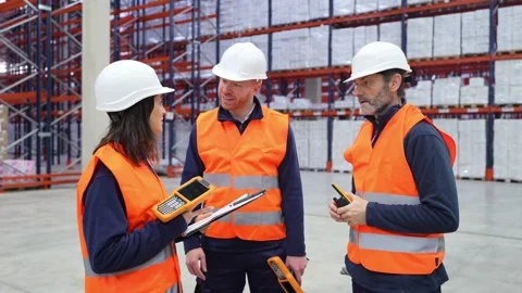 Warehouse workers discussing logistics and inventory management Stock Footage 312856375