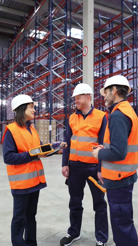 Warehouse workers discussing logistics with digital tablet Stock Footage 312856490
