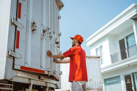 Warehouse workers lock iron container doors while working Stock Photos