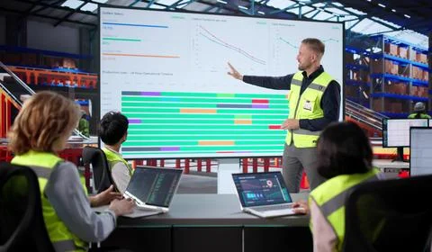 Warehouse Workers Meet With Manager, Analyze Data On Laptop Screen. African T Stock Photos