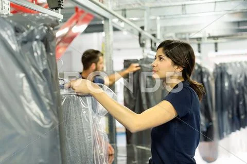 Warehouse Workers Preparing Garment Orders In Distribution Warehouse
