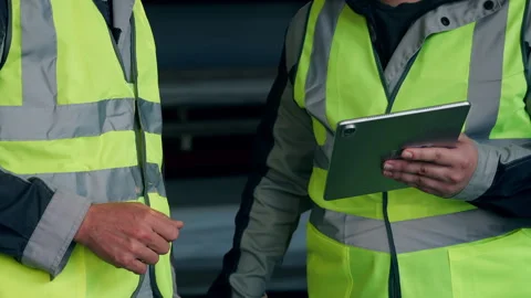 Warehouse Workers Reviewing Inventory Data on Digital Tablet. Stock Footage 345012695