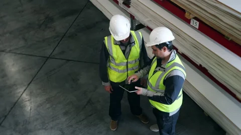 Warehouse Workers Reviewing Inventory Data on Digital Tablet. Stock Footage 345013139