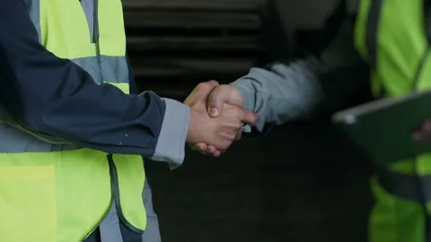 Warehouse Workers Shaking Hands After Successful Agreement. Stock Footage 345012588