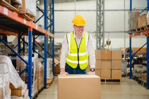 Warehouse workers talking together checking goods in storage Stock Photos