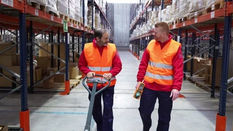 Warehouse workers transporting goods with pallet jack Stock-Footage 312856346